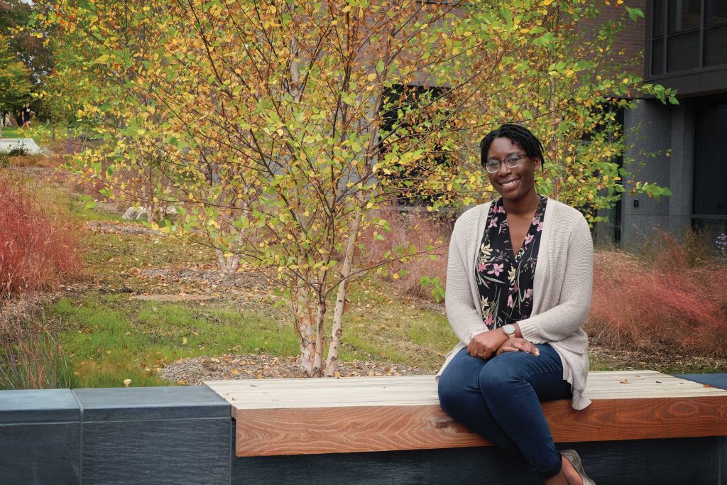 Shivon_DSCF0154-copy Portrait of Shivon Robinson sitting outside on a wooden bench