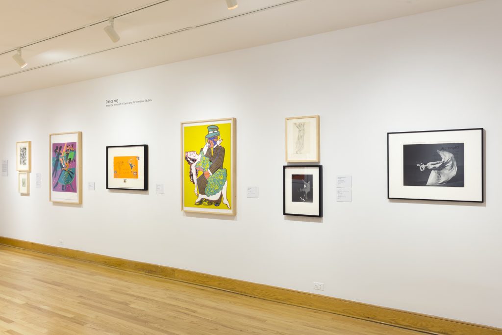 Museum wall with artwork from the Dance 103 course.