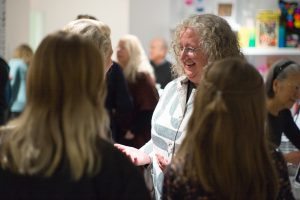 Maggie Adler ’99, MA’11, talks to museum goers during the opening for the exhibition Emancipation.