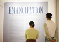two people read the wall label for the Williams College Museum of Art exhibition, Emancipation