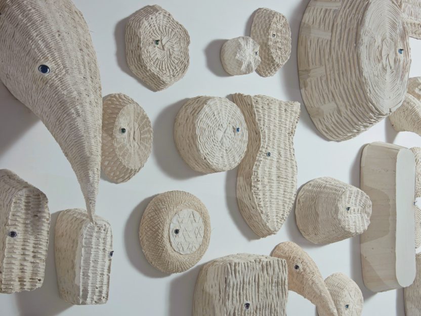 A photo of Amy Podmore's white plaster casks of baskets on view in the MASS MoCA exhibition.