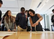 Julia Rossi, second from right, turns the page of an issue of the Frederick Douglass' Monthly in the instruction room at the Chapin Library.