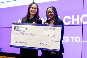 Two people hold a giant check from Williams for audience choice, $4,000.