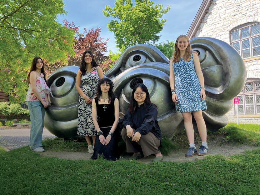 Photo of WCMA summer interns posing in front of a sculpture on campus