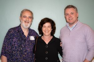 From left: Williams Sports Information Director Dick Quinn, President Maud Mandel and filmmaker Jason Hehir, Class of 1998, post for a photograph.