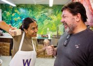 Photo of a student showing her pottery project to her Winter Study instructor